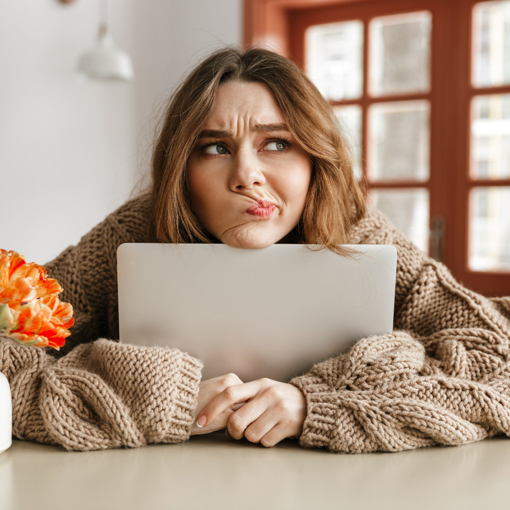 Confused Girl Holding Computer